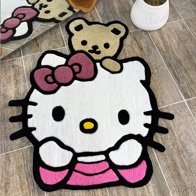 El yapımı tasarım süreçleriyle öne çıkan, pembe fiyonklu Hello Kitty ve sevimli kahverengi ayıcık figürlü beyaz tufting halı modellerini içeren, yumuşak dokulu ve dekoratif Hello Kitty tufting halısı koleksiyonu kategori görseli.