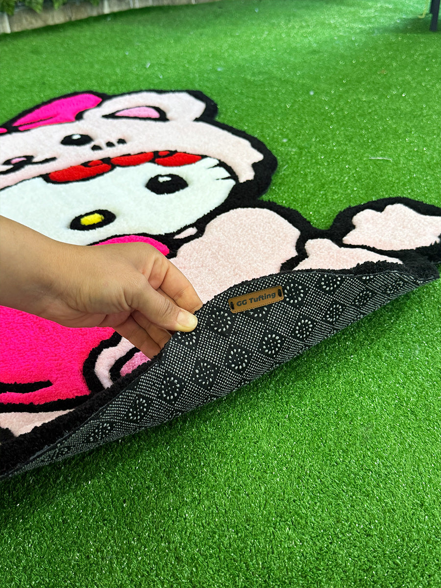 Kaydırmaz taban dokusu ve GG Tufting deri etiketi yakından gösterilen Hello Kitty Pink Edition el yapımı tufting halı arka yüzeyi.