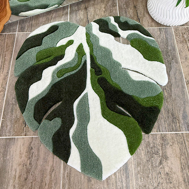 Modern ev dekorasyonuna doğallık katan devetabanı yaprağı formunda, koyu yeşil, açık yeşil ve beyaz tonların estetik bir harmonisiyle dokunan bitki temalı tufting halı koleksiyonlarını temsil eden kapsamlı kategori görseli.